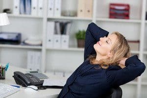 Businesswoman Relaxing With Hands Behind Head